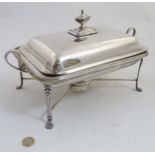 A silver plate entree / chaffing dish on four footed stand with burner under 14"wide