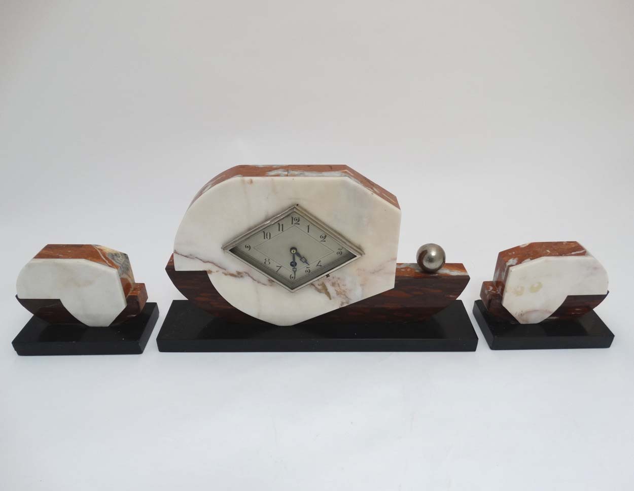 Art Deco Clock and Garnitures: an attractively cased marble timepiece with diamond shaped dial,