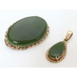 A 9ct gold brooch set with green jade like cabochon 1 /4" wide together with a matching pendant (2)