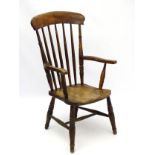 A 19thC Windsor chair with elm seat and beech spindle back,