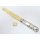 A late 19thC / early 20thC French silver handled page turner with ivory blade.