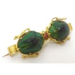 A gilt metal bar brooch set with 2 scarab beetle decoration CONDITION: Please Note