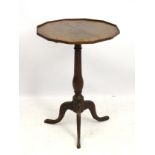 An early 19thC oak occasional table with a twelve sided top and a turned central column,