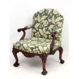 An early 19thC Chippendale mahogany open elbow chair with upholstered back and seat.