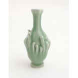 A small Chinese Celadon garlic head vase having stem like tendril decoration to sides,