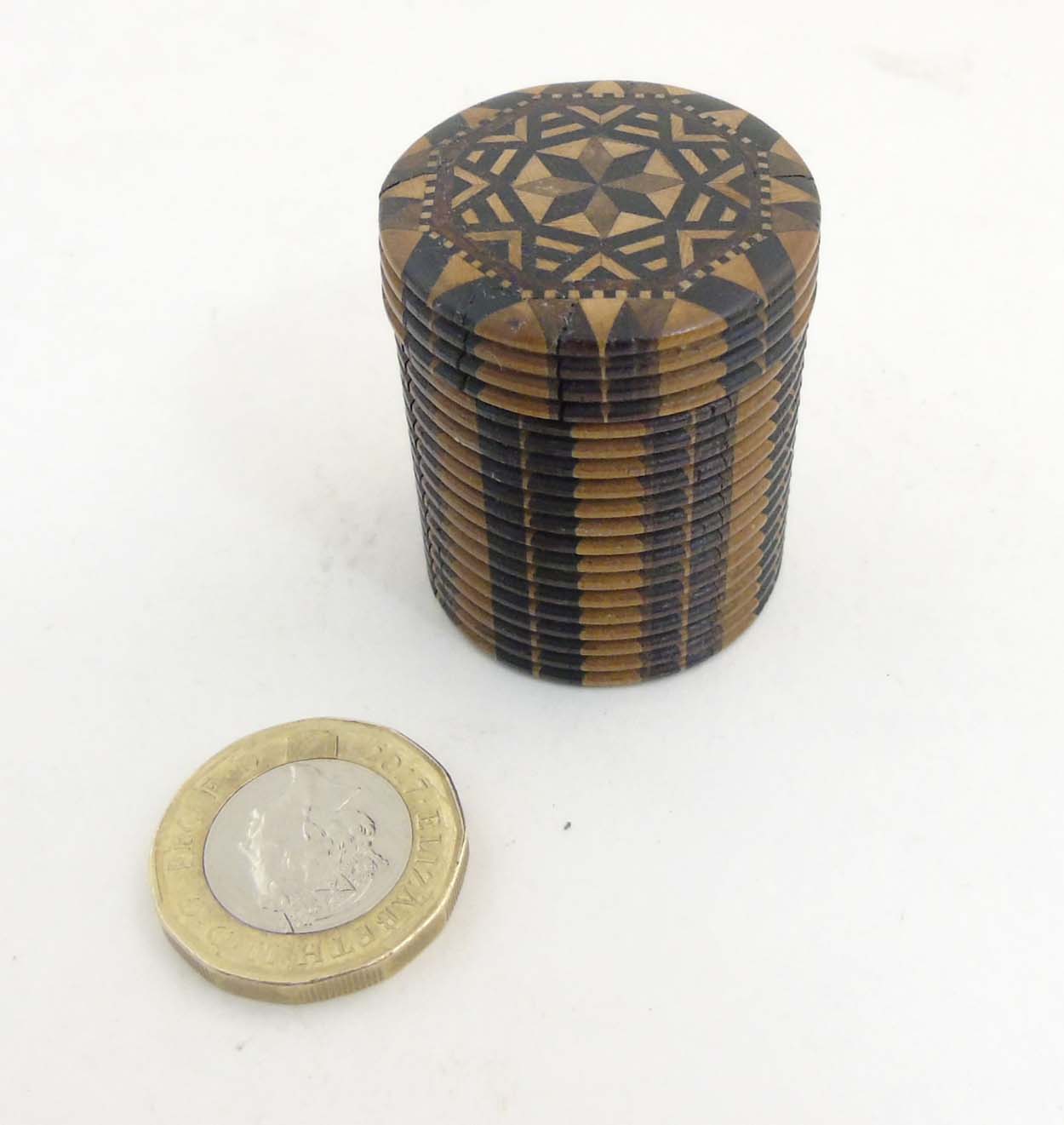 A Tunbridge 19thC stick ware parquetry games counter box of cylindrical form with screw lid.