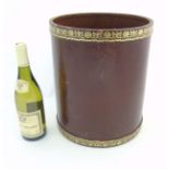 A mid - late 20thC leather waste paper bin of cylindrical form with green tooled decoration.