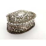 A Victorian silver small box with embossed decoration.