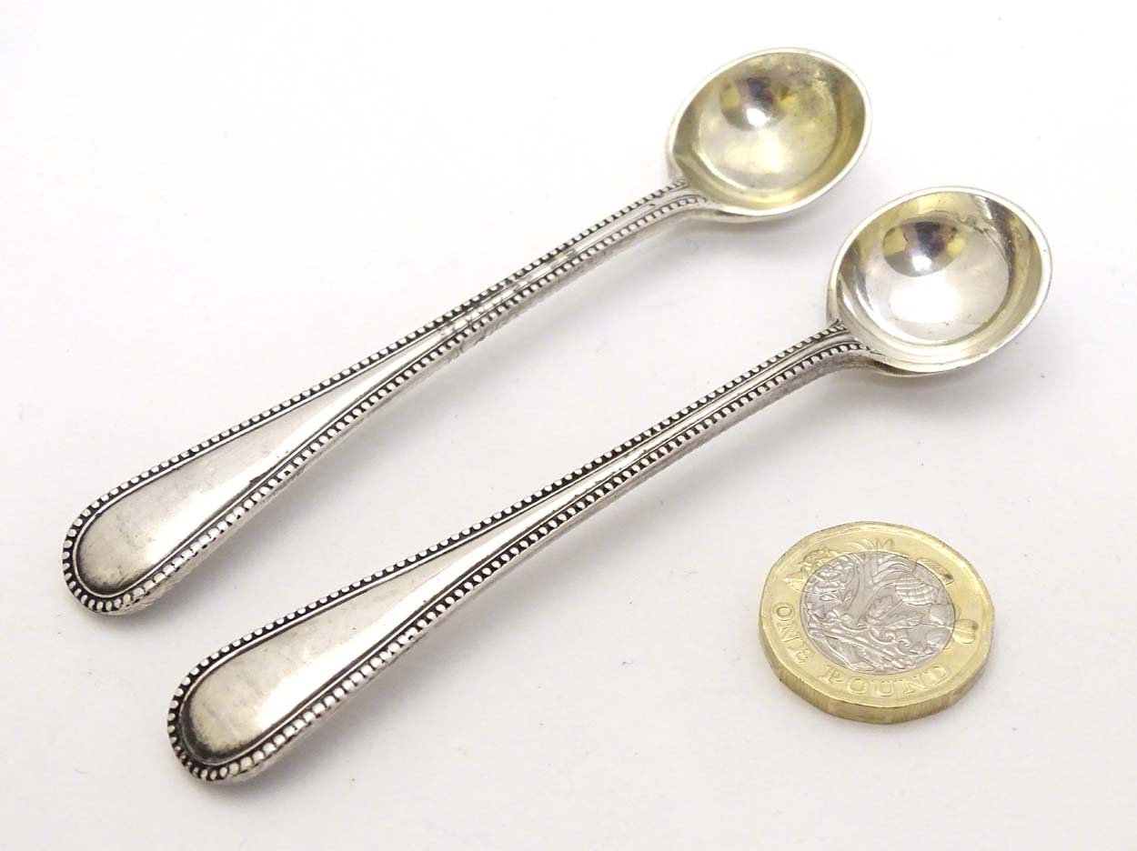 A pair of Victorian silver bead edge salt spoons hallmarked London 1886 maker John Aldwinckle &