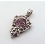 A silver pendant set with red stones approx 4" long CONDITION: Please Note - we do