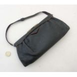 A Black leather clutch bag with red trim, small handle,
