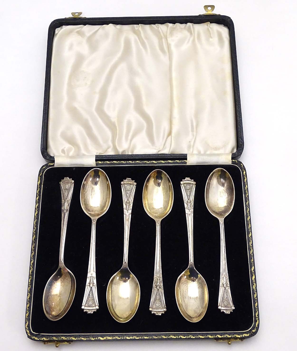 A cased set of 6 silver teaspoons having unusual celtic like decoration with wild boar head detail.