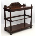A William IV mahogany three tier dumb waiter with carved scrolling pediment,