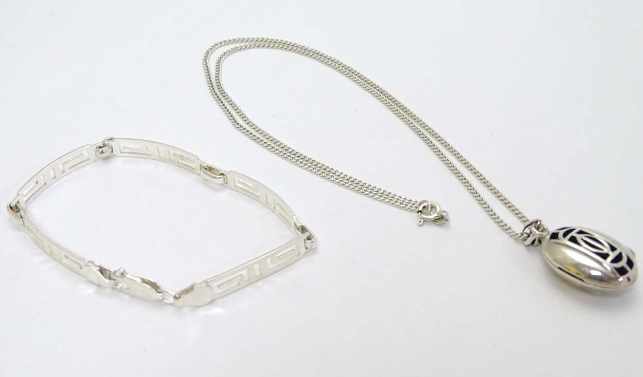 A silver bracelet with Greek Key decoration together with a silver necklace with pendant inspired