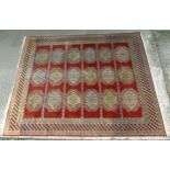 Rug & Carpet : a hand made woollen Russian carpet having a red background with 18 (6x3)white yellow