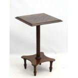 An unusual 19thC tilt top table, with fluted column leading to a shaped base,