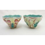 A pair of Chinese moulded flower cups formed as stylised peonies flowers balanced on leaves and