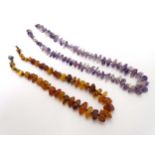 An amethyst hardstone bead necklace together with a necklace of graduate amber beads (2)Prov: