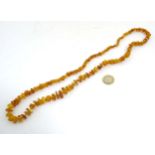 A Vintage amber bead necklace of graduated amber chips/ beads.