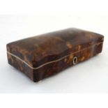 A 19thC tortoiseshell box of cupids bow shape with velvet lining on squat bun feet.