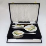 A cased matched silver backed dressing table set comprising brushes and come,