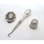 A Victorian silver brooch hallmarked 1884 together with a silver handled small button hook