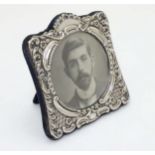A photograph frame with silver surround hallmarked Birmingham 1904 maker Britton Gould & Co.