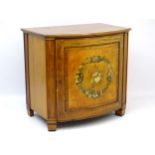 An early / mid 19thC bow fronted satinwood commode cabinet with cross banded inlay and intricately