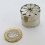 A silver plate pill box with mother of pearl decoration to lid 1" diameter CONDITION: