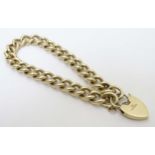 A 9ct gold curblink bracelet with padlock formed clasp (36g) CONDITION: Please Note