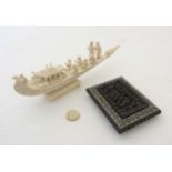 A 19thC Indian carved ivory model of a wedding barge? with 7 figures upon and elephant head and