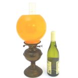 Vintage Retro : a burnt orange globe on a brass Duplex oil lamp with twin burners,