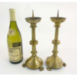 Gothic Revival : A pair of brass 3 footed pricket candlesticks with trefoil decoration.