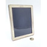 A silver photograph frame with easel / strut back. Hallmarked Birmingham 2000 maker B&Co.