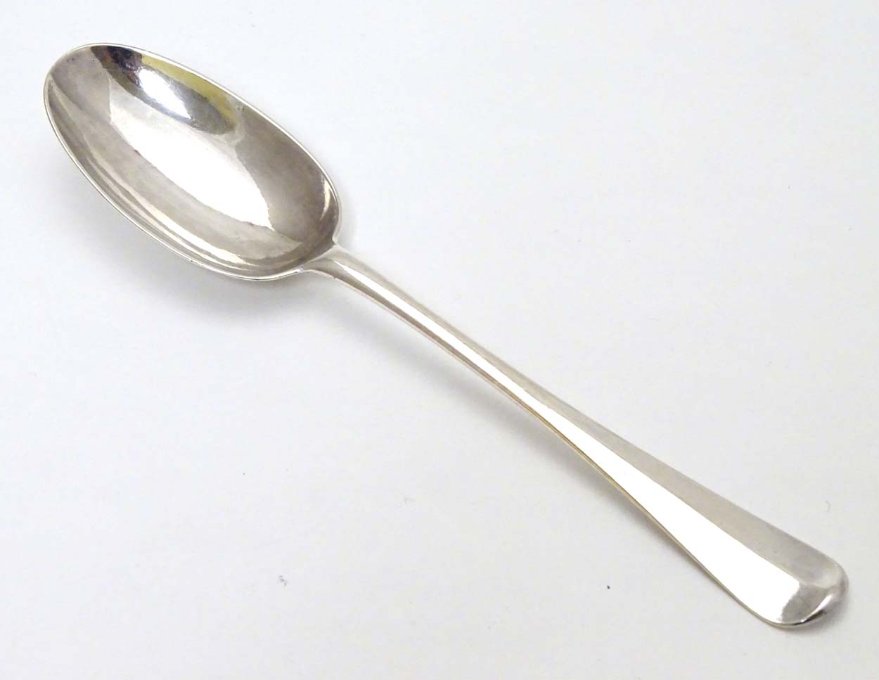 A Queen Anne Britannia Standard silver Hanoverian table spoon with rat tail bowl.