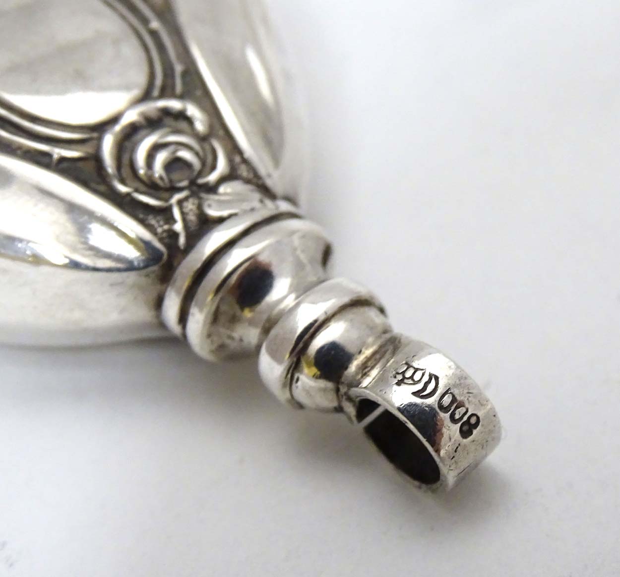 A Continental 800 silver pendant rattle with rose decoration 2 1/4" long CONDITION: - Image 2 of 5