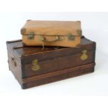 A large leather suitcase with brass fittings together with a wooden bound canvas travel trunk.