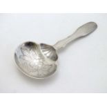 A Continental / Portuguese .833 silver caddy spoon with engraved decoration to bowl.