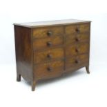 An unusual Georgian flame mahogany chest of drawers comprising eight short draws with squared top