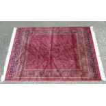 Rug Carpet : A late 20 thC machine made Bokhara rug with red ground ,