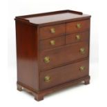 A mid 20thC mahogany chest of drawers comprising four long draws with Georgian style handles and a