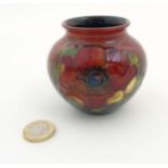 A small Moorcroft '' Anemone '' pattern flambe vase,