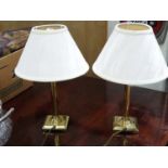 A pair of brass lamps with fitted white light shades CONDITION: Please Note - we do