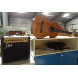 A Spanish classical guitar together with an electric guitar amp player, music stand,