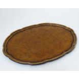 A walnut oval tray with pie crust deocration CONDITION: Please Note - we do not