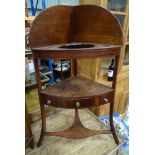 A Georgian mahogany corner washstand with ebony stringing and three tiers with central drawer