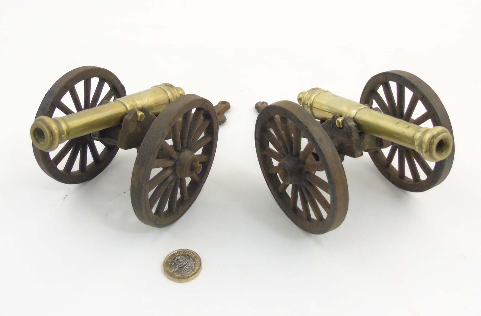 A pair of c.1900 cast iron and brass desk cannons.