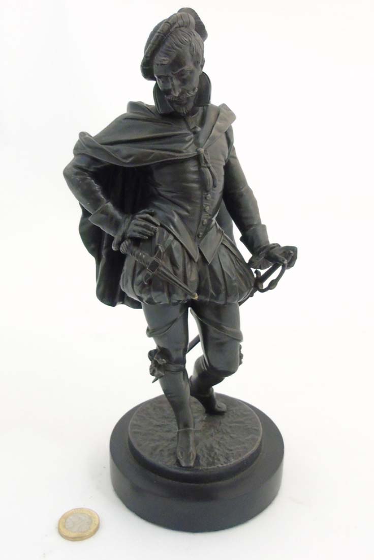 A 20thC Spelter figure of an Elizabethan Gentleman with sword, dagger etc.