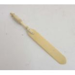 An Edwardian carved paperknife with turned and fluted handle , 6 3/4" long.
