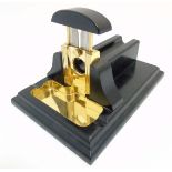 A late 20thC desk top cigar cutter in the form of a guillotine.